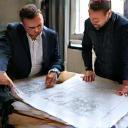 Consultants discussing blueprints